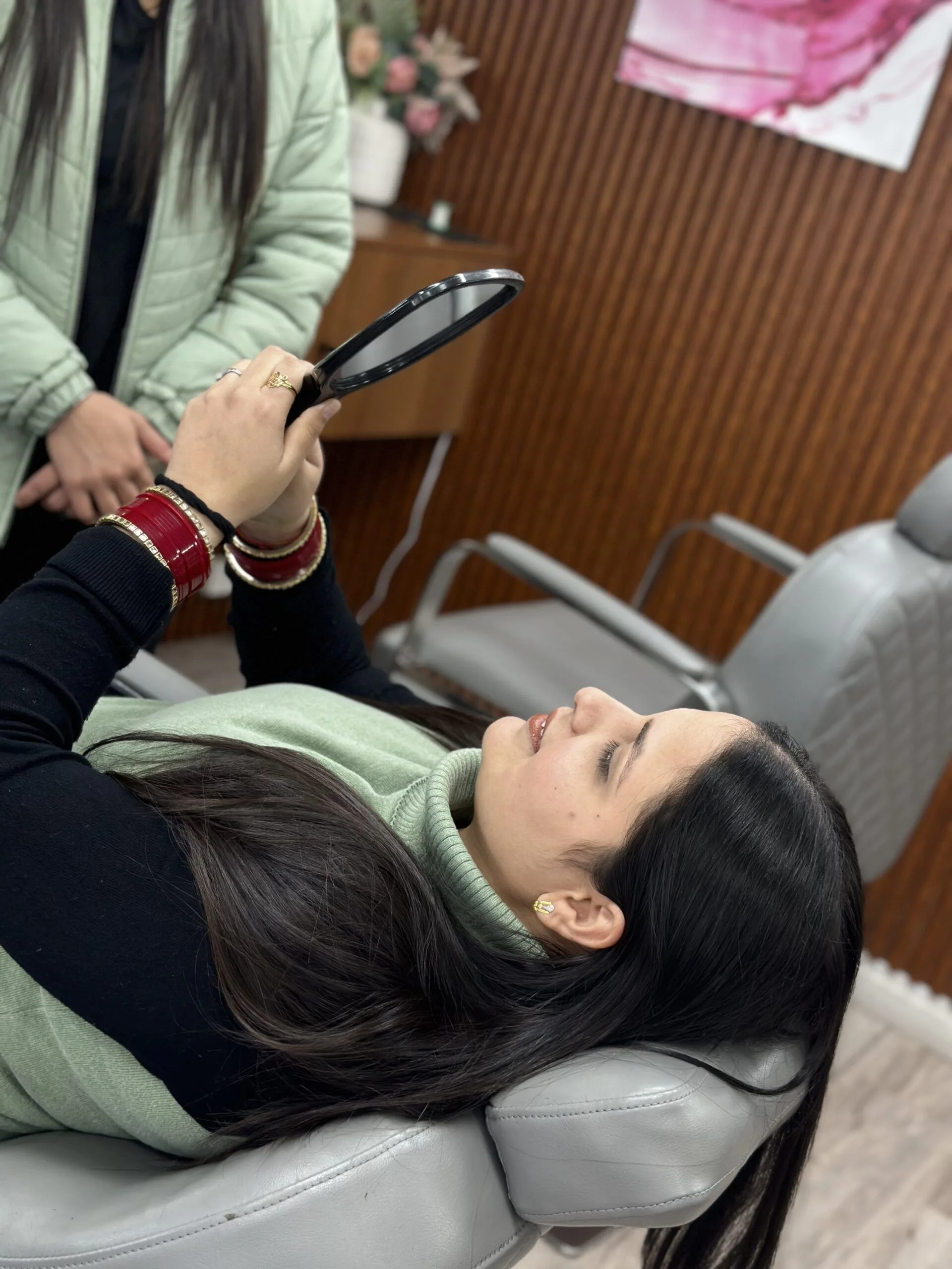 Client admiring her results in mirror